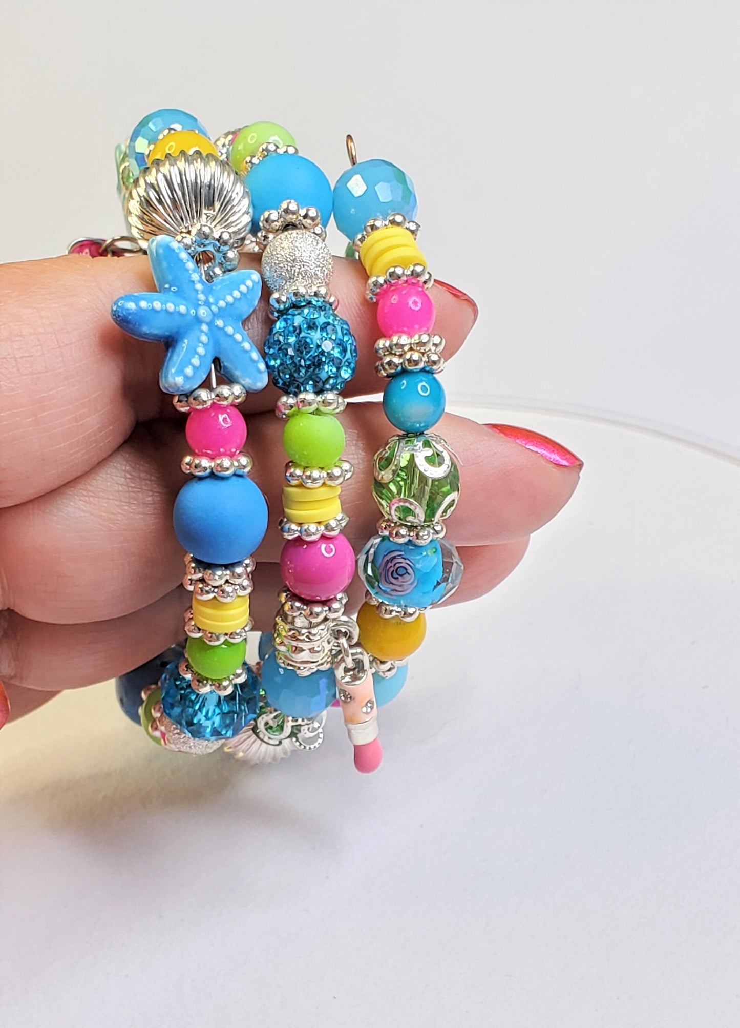 Whimsical Charm Bracelet featuring a lipstick, handbag, starfish and dress charms, 3 Coil Memory Wire Bracelet